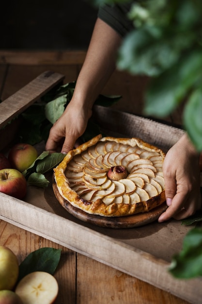 Free photo high angle hands holding apple dessert