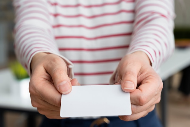 High angle hands holding business card