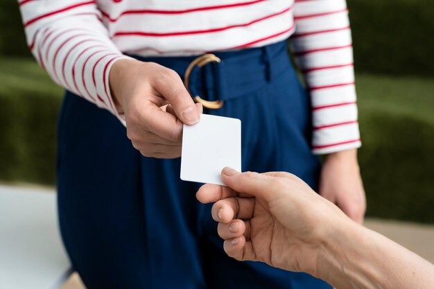 High angle hands holding business card