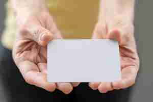 Free photo high angle hands holding business card