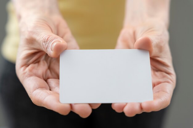 High angle hands holding business card