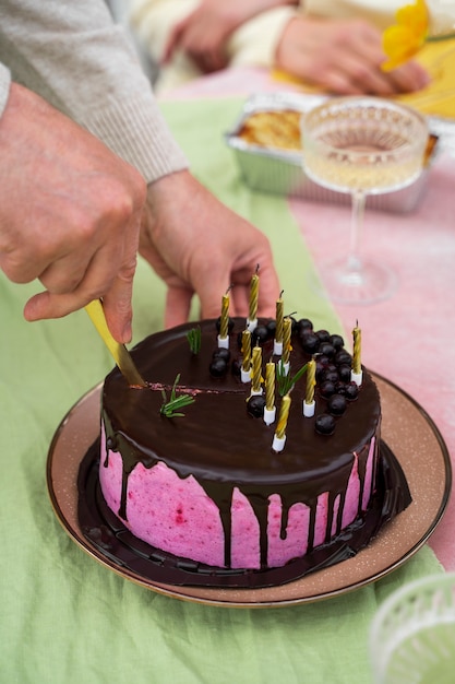 Free photo high angle hands holding cake