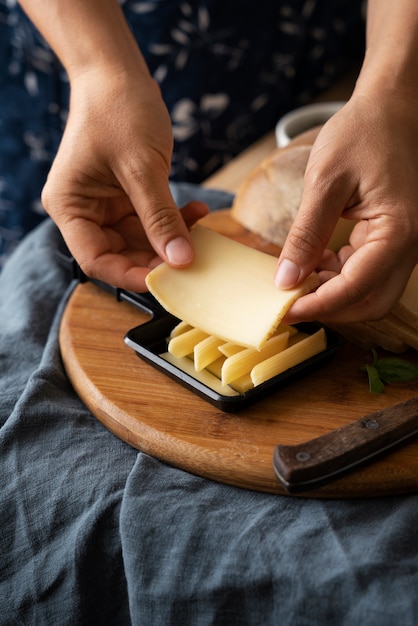 High angle hands holding cheese slice