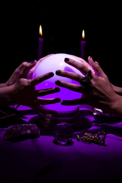 Free photo high angle hands holding crystal ball