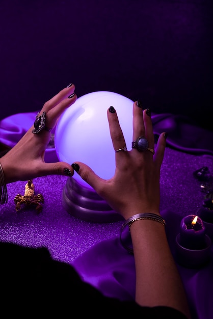 High angle hands holding crystal ball