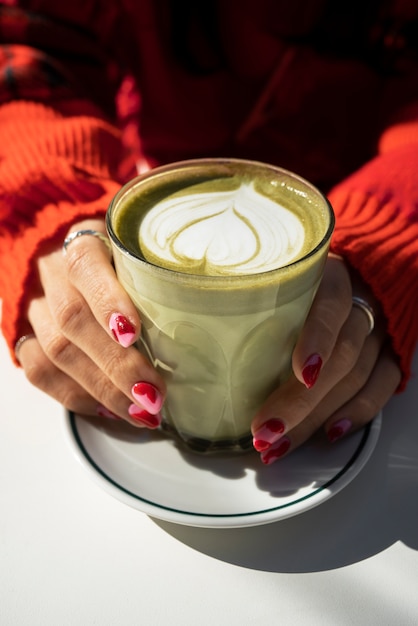 High angle hands holding delicious drink