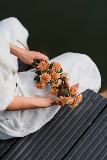 High angle hands holding flowers