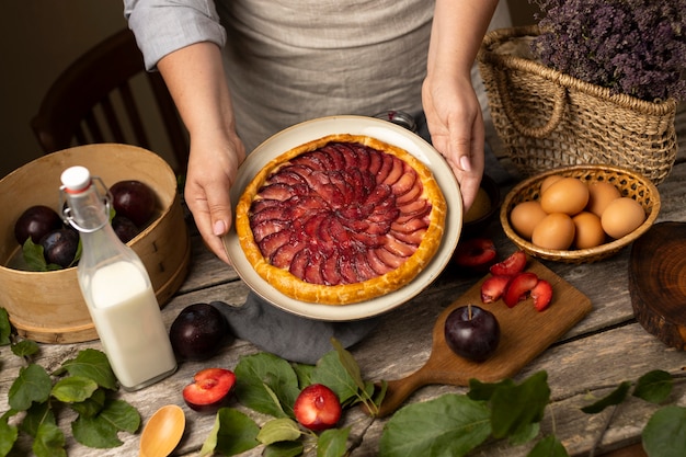 High angle hands holding plate with pie