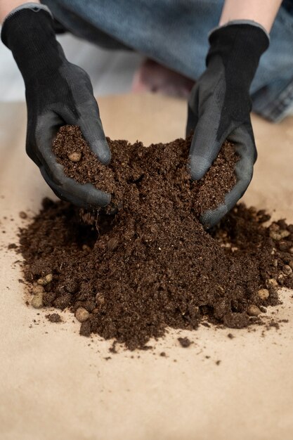 High angle hands holding potting soil