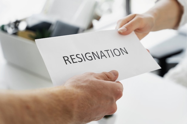 Free photo high angle hands holding resignation note