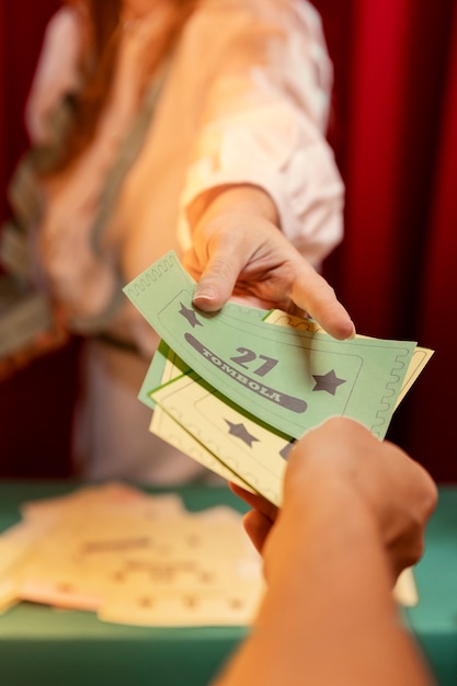 High angle hands holding tombola tickets