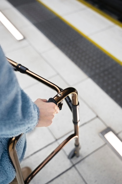 High angle hands holding walking frame