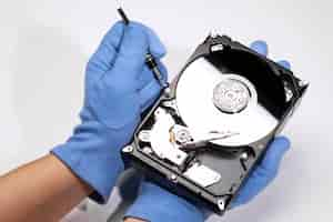 Free photo high angle hands repairing hard drive