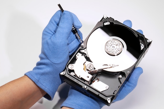 High angle hands repairing hard drive