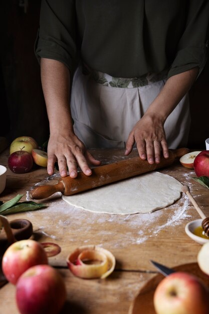 High angle hands rolling out the dough