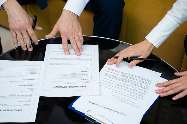 High angle hands signing documents