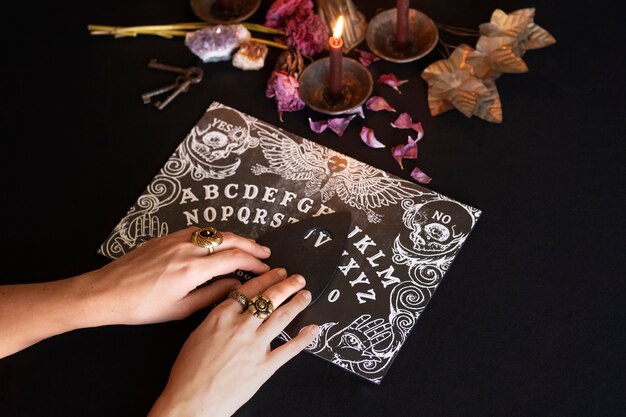 High angle hands using old ouija spiritual board