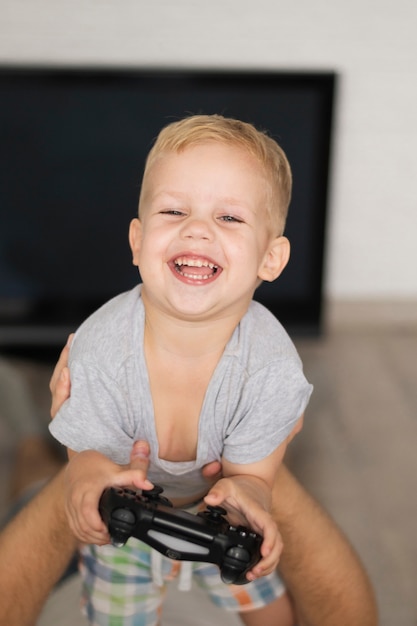 Free photo high angle happy child playing games with father