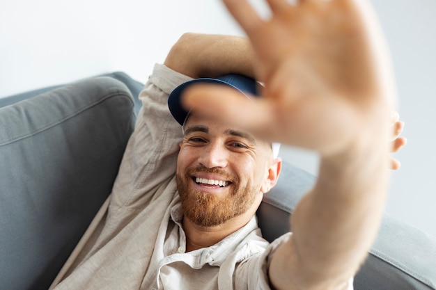 High angle happy man posing with trucker hat