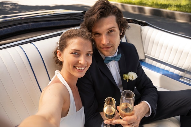 Free photo high angle happy married couple with drinks