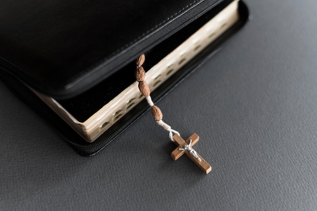 Free photo high angle of holy book with cross