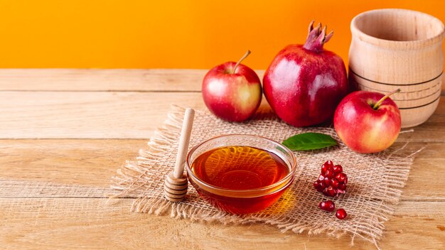 High angle honey bowl with dipper and fruits