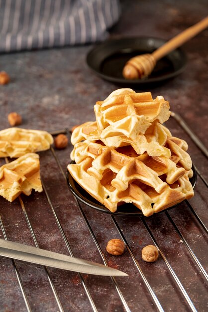 High angle of honey covered stack of waffles on plate