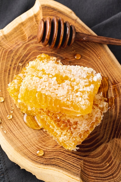 High angle honeycombs with dipper on wooden platter