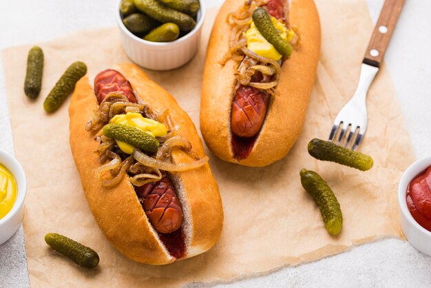 High angle hot dogs with mustard and onion