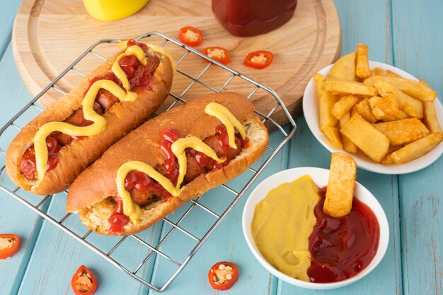 High angle of hot dogs with potatoes and ketchup and mustard