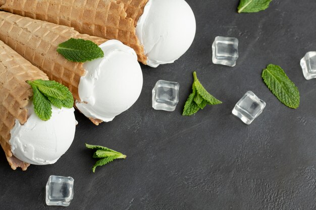 High angle ice cream on cones with ice cubes