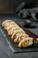 Free photo high angle japanese dumplings arrangement