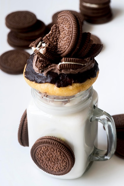 Free photo high angle of jar of dessert with biscuits and donut