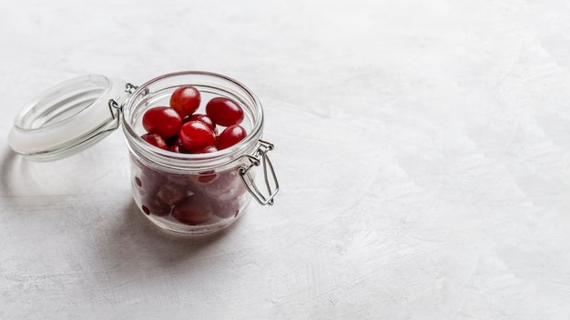 High angle jar with red grapes