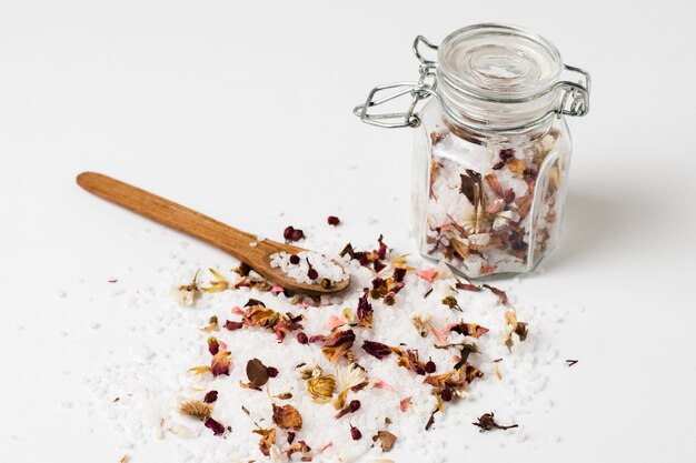 High angle jar with salt, plant and spoon