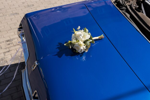 High angle just married car scene with flowers