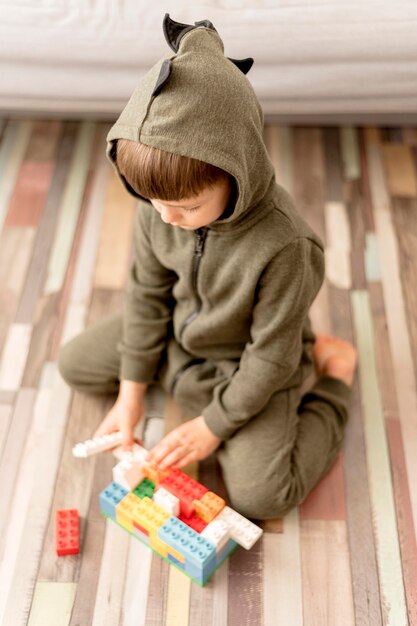 High angle kid wearing dragon costume