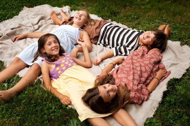 high angle kids laying on blanket