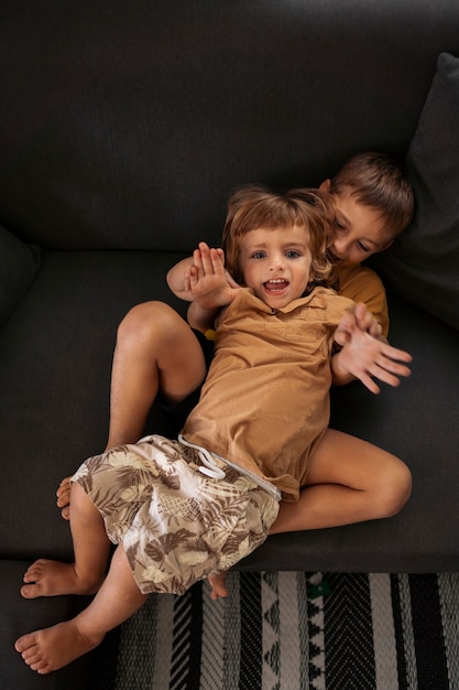 High angle kids laying on couch