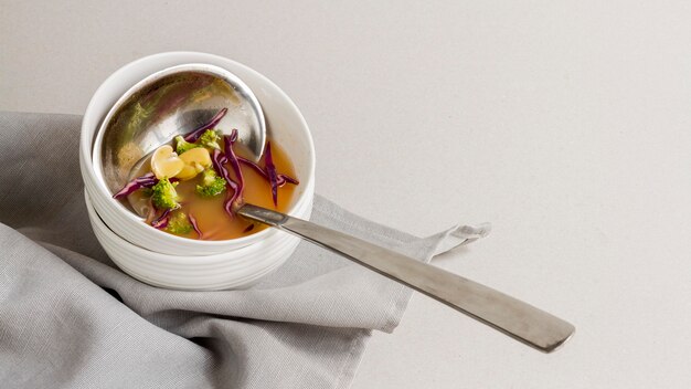 High angle ladle in bowl with bean soup