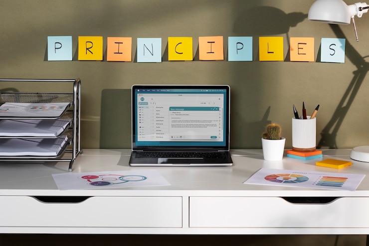 Free Photo high angle laptop on desk and colorful post its