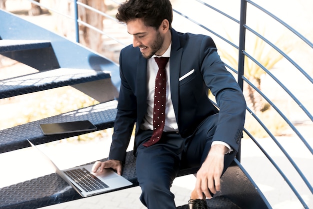 High angle lawyer in suit working on laptop