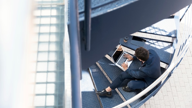 Free photo high angle lawyer working on the stairs