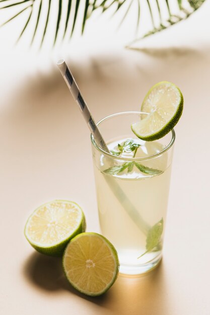 High angle of lemonade glass on plain background