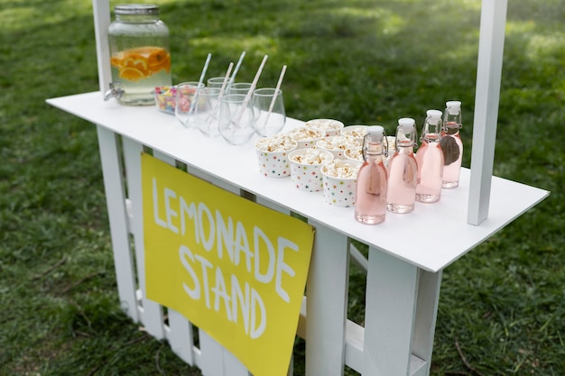 High angle lemonade stand with popcorn