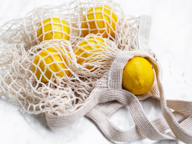 Foto gratuita limoni ad alto angolo in sacchetto di rete di cotone