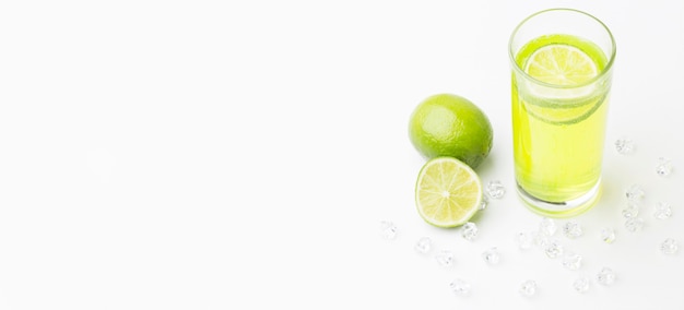High angle of lime juice in glass with copy space