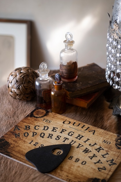 Free photo high angle little bottles and ouija board