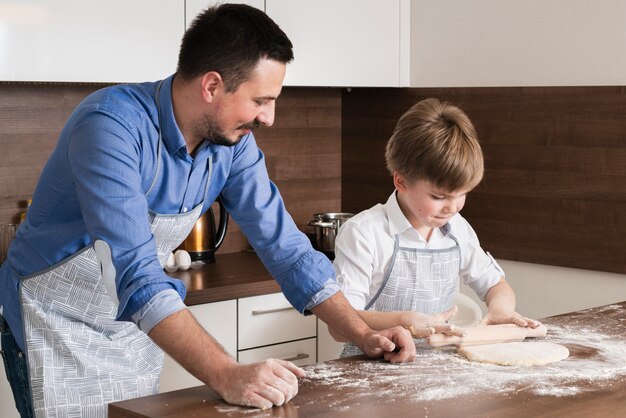 High angle little boy rolling dough