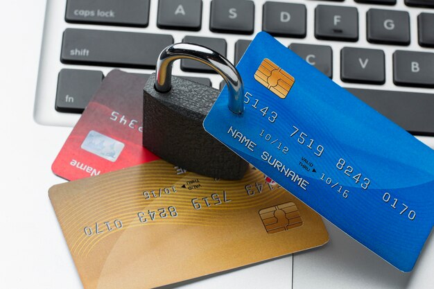 high angle of lock with credit cards on top of laptop